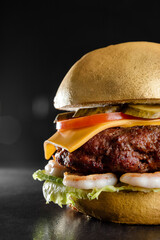photo of a juicy burger with cutlet, salad, cheese, and fried shrimp which is painted with edible...
