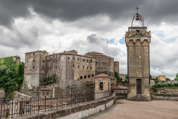 picturesque view of Sorano with old staircase, alley, underpass and plants in the Tuscan medieval...
