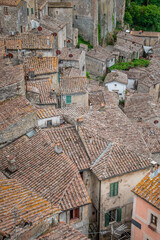 picturesque view of Sorano with old staircase, alley, underpass and plants in the Tuscan medieval village