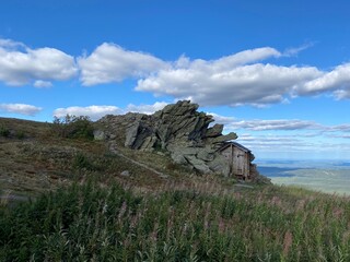 Outdoor wood toilet in mountains. The unusual toilet on the top of the Far Taganay mountain. Weather station « Taganay-mountain» of Taganay national Park. Zlatoust city. Chelyabinsk region. South Ural