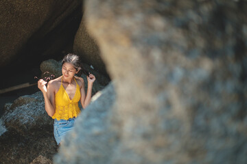 women portrait on the tropical beach wear yellow , rock beach, Crystal bay, Lamai , koh samui ,Suratthani ,thailand