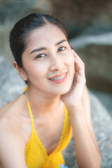 women portrait on the tropical beach wear yellow , rock beach, Crystal bay, Lamai , koh samui ,Suratthani ,thailand