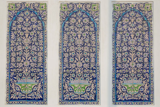Closeup view of ancient ceramic tiles panels with blue and white traditional floral motif on exterior wall of Makhdum Nuh tomb in Hala, Sindh, Pakistan