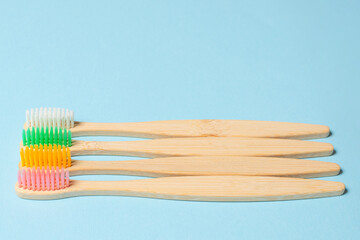 Bamboo toothbrush on a blue background.