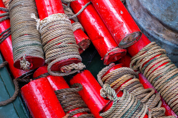 Folded marker buoys on a military boat. Dry red floats with a rope. Device - a sea node, a unit of...