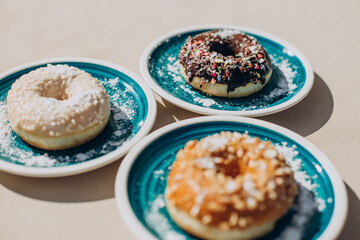 Fresh delicious donuts on plate