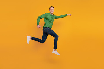 Fototapeta na wymiar Portrait of superhero funky guy jump run save world on yellow background