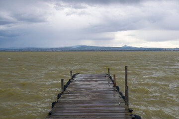 Fototapeta premium View of the jetty in La albufera during a cloudy day. Valencia - Spain