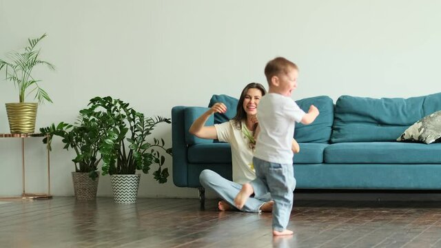 Happy mother day. child son congratulates mother on holiday and gives flowers. congratulating her on mother's day during holiday celebration at home