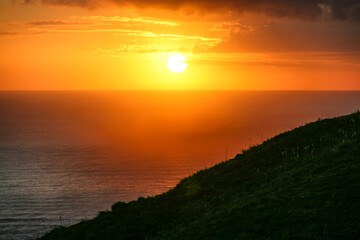Sunset in the Mediterranean with a bright, orange sky