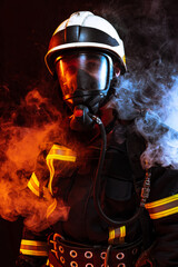 One uniformed firefighter posing against black background covered in smoke