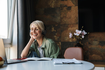 Middle aged blonde woman with short hair studying