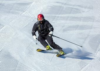 professional skier at speed in a turn. a screensaver with a ski slope with traces after a...