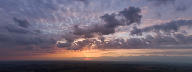 Fototapeta na wymiar Amazing sunrise, beautiful panorama of morning sun and cloudy sky.