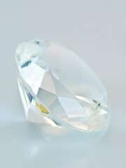 Transparent blue tinted round gemstone, lateral view