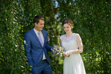 Happy young bride and groom on  wedding day. Wedding couple - new family! wedding dress. Bridal wedding bouquet of flowers