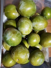 box of organic green plums