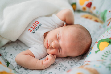 Beautiful tree week baby boy sleeping.