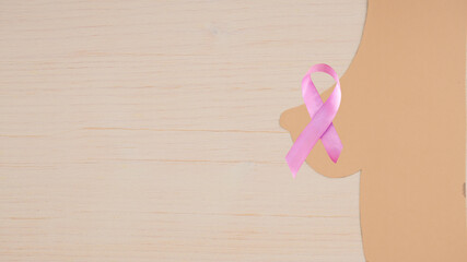 Silhouette of a woman's breast with a breast cancer awareness ribbon