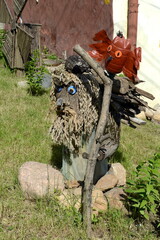 The figure of the Goblin-a fairy-tale character on the flower bed of the city palace