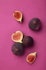 Fresh ripe figs on pink background. Tropical fruit