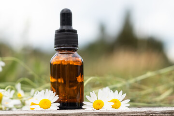 serum with chamomile extract on the background of the sky, concept natural cosmetics,copy spase