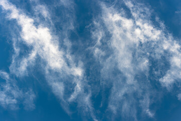 Bottom view of fluffy white cloud on deep blue sky