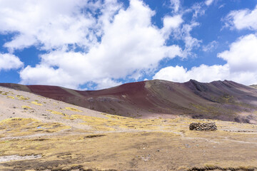 Fototapeta na wymiar Rainbow Mountain, is a mountain in the Andes of Peru with an altitude of 5,200 metres above sea level. It is located on the road to the Ausangate mountain.