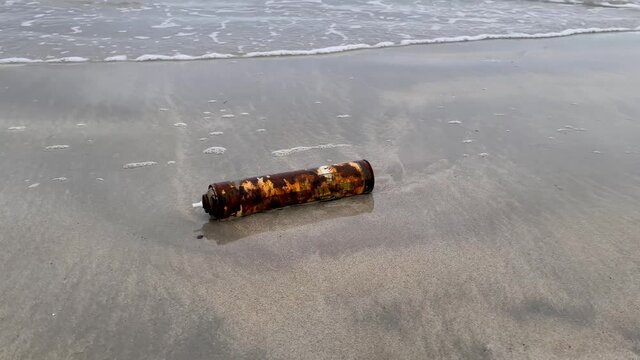 Rusty spray can stranded on beach in Ireland