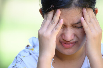 asian woman suffering from depression, headache, burnout,fear of covid 19; health care concept