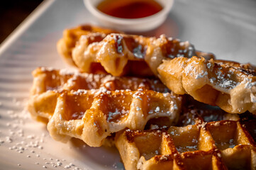 Waffles with powdered sugar on plate close up