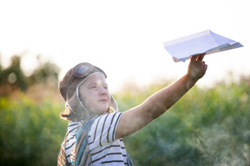 Happy child playing aviatos outdoors. Travel and adventure concept