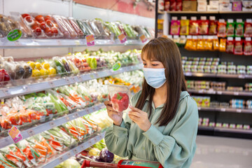Women wear masks to shop vegetable bell pepper in supermarkets, new normal lifestyles in the era of the Corona virus or Covid-19 epidemic