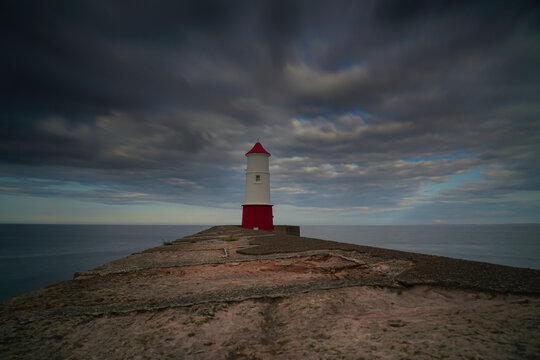 Berwick Upon Tweed lighthouse with dramatic skies above. located in Northumberland, England.