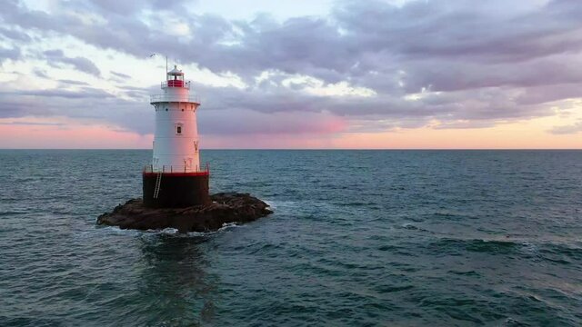 Passing Sakonnet Point lighthouse at dusk, aerial view