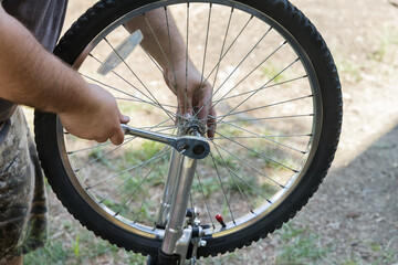 Man repairing bicycles a handsome bike mechanic in working process