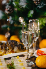 table on which there are traditional New Year's dishes prepared on the table in the Soviet Union: jellies with meat, olives, potatoes, baked chicken, grated horseradish, sausage, pate, vodka and champ