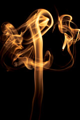 Gold smoke on black background.