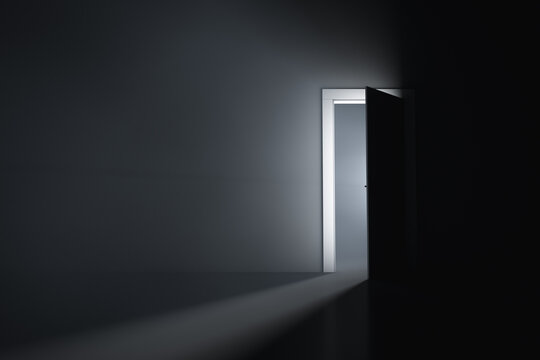 A slightly open door in a dark room
