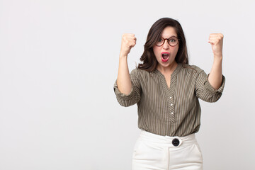 pretty woman celebrating an unbelievable success like a winner, looking excited and happy saying...