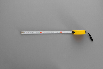 Yellow construction roulette on a gray background