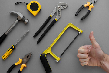 Flat lay composition with construction and home repair tools tools on grey background, space for text