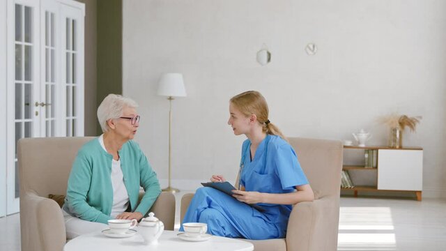 Senior woman talks to young doctor at long term care home