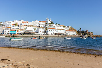 Naklejka na ściany i meble Cityscape of Ferragudo with boats in the foreground, Algarve, Portugal
