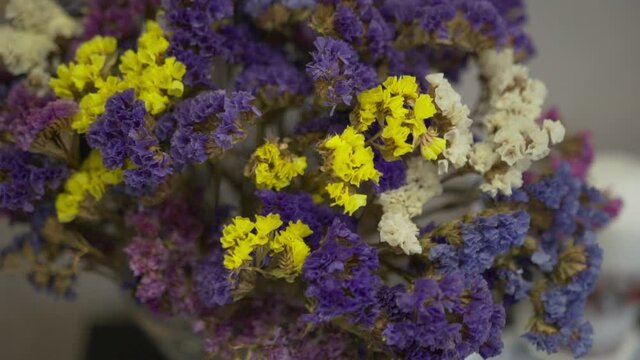 Bouquet of dried flowers. Limonium flowers are yellow, white, blue and purple.