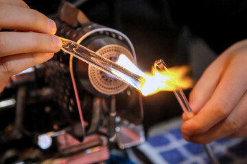 Glasstäbchen werden erhitzt um sie künstlerisch weiter zu bearbeiten.
