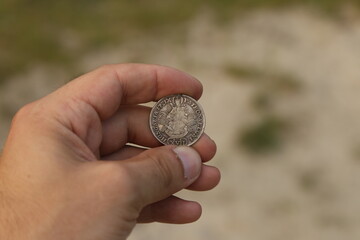 Vintage silver coin in hand