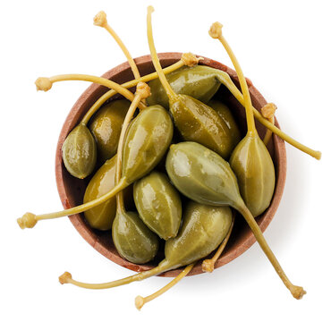 Pickled capers in a plate on a white background, isolated. Top view