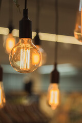 Hot-colored lamp in designer clothing store, giving a coziness aspect in the environment, aesthetically very cool.