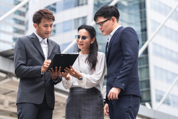 Business people with laptop computer discussion and work together at outdoor